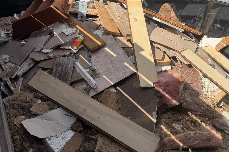Flooring planks, drywall and insulation from a tear-out loaded in a trailer