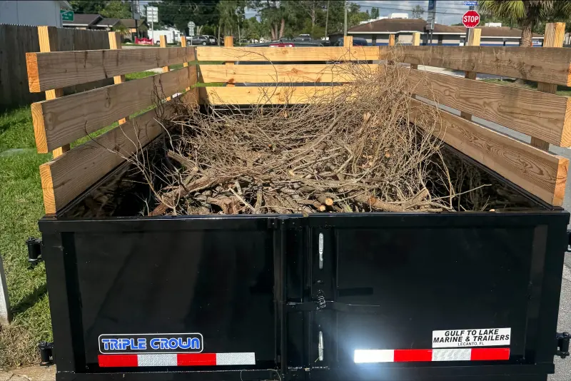 On Scene trailer with wood side extensions loaded with cut branches